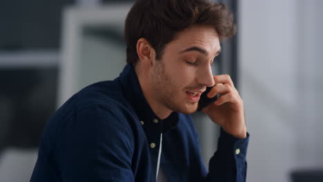 Closeup-smiling-man-talking-mobile-in-office.-Cheerful-guy-having-phone-call