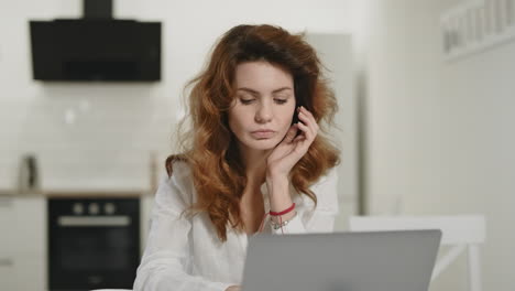 White-woman-working-notebook-at-home.-Shocked-lady-reading-information-on-laptop