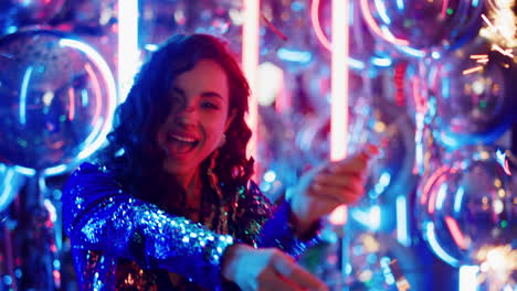 Smiling-girl-dancing-with-bengal-lights-in-club.-Woman-partying-under-confetti