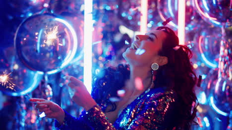 Joyful-woman-dancing-with-bengal-lights-in-club.-Girl-having-fun-in-nightclub