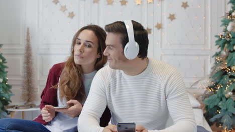 Happy-couple-enjoying-music-in-earphones-together.