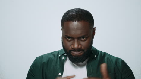 Closeup-indignant-african-american-man-threatening-on-light-background.