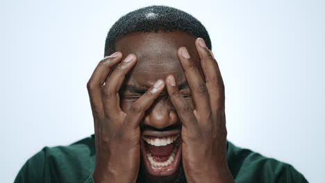 Shocked-african-american-man-screaming-in-light-background.-Afro-guy-shouting