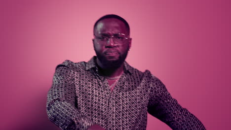 African-american-man-dancing-on-pink-background.-Afro-guy-having-fun-in-studio