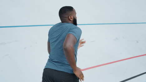 Afro-man-running-on-track.-Male-runner-jogging-on-athletics-track