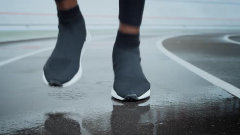 Jogger-in-sports-shoes-running-on-spot.-Man-legs-running-on-racetrack