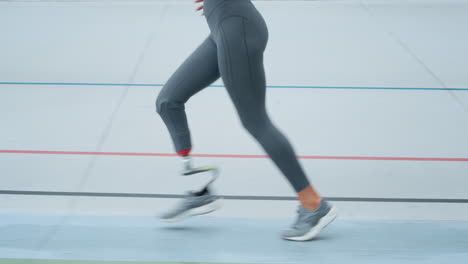 Jogger-with-artificial-limb-doing-cardio-on-track.-Athlete-running-outdoors