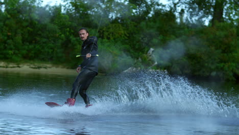 Man-riding-wakeboard-on-motorboat-wave.-Rider-in-training-wake-boarding