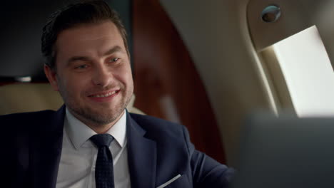 Smiling-ceo-talk-online-on-business-trip-closeup.-Successful-manager-chatting