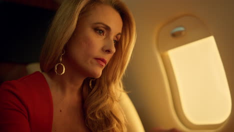 Financial-ceo-working-laptop-on-private-aircraft-closeup.-Focused-elegant-blonde