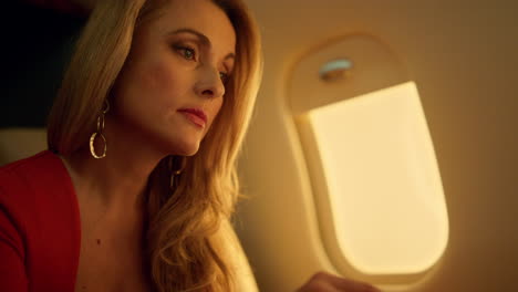 Elegant-entrepreneur-look-laptop-on-corporate-flight-closeup.-Ceo-business-trip