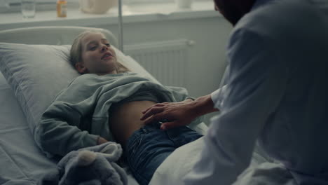 Physician-visit-patient-ward-after-therapy.-Cute-girl-lying-in-hospital-bed.
