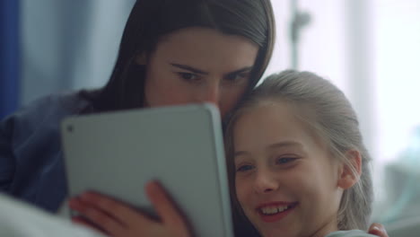 Family-enjoy-playing-tablet-computer-closeup.-Joyful-mom-kid-have-fun-together.