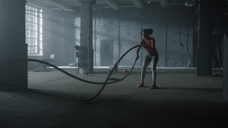 Woman-doing-workout-with-battle-ropes.-Girl-performing-crossfit-exercise