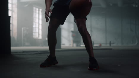 Sportsman-legs-playing-basketball.-Afro-man-hands-bouncing-basketball-ball