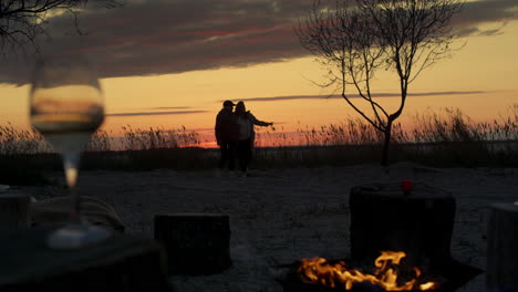 Romantisches-Paar-Geht-Am-Strand-Bei-Sonnenuntergang-Am-Lagerfeuer-In-Der-Meereslandschaft-Spazieren.