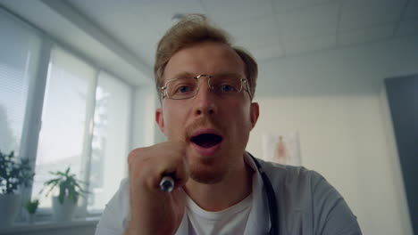 Portrait-doctor-checking-throat-using-depressor-pov-video.-First-person-view.