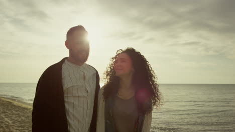 Happy-lovers-walking-sea-sunset-beach-outdoors.-Hispanic-couple-enjoy-coast.