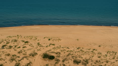 Aerial-beach-view-with-peaceful-calm-sea-surface-washing-on-coastline.