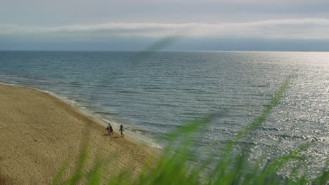 Peaceful-sea-beach-coast.-Family-walking-on-nature-sandy-shore-island-background