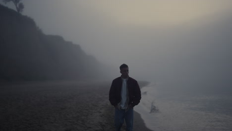 Sad-man-walking-sea-shore.-Upset-guy-feeling-lonely.-Model-looking-foggy-ocean