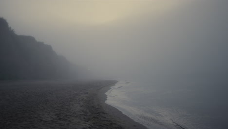 Scenic-view-rocky-beach-in-morning-fog.-Sea-landscape-at-sunrise