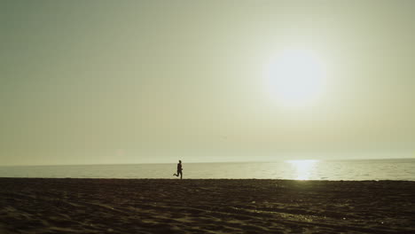 Unknown-sportswoman-running-seaside.-Silhouette-jogging-woman-on-sunset.