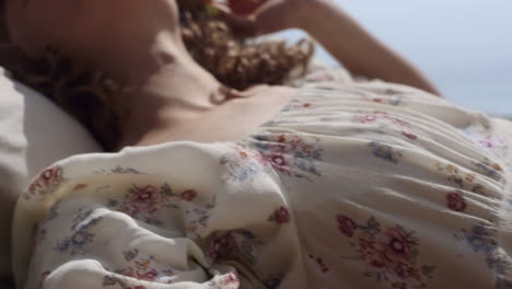 Closeup-woman-body-lying-sunny-beach-on-young-boyfriend.-Couple-enjoy-nature.
