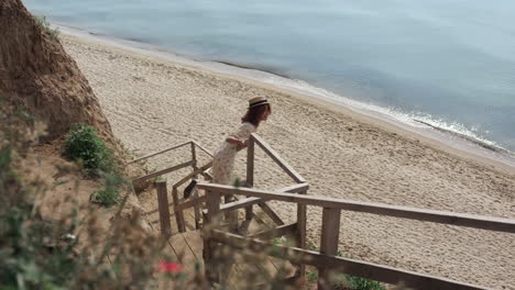 Active-girl-watching-seascape-standing-beach-ladder.-Woman-running-to-ocean.
