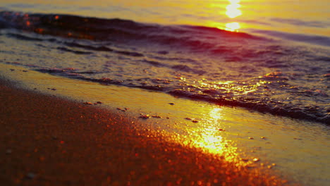 Close-up-sea-waves-splashing-summer-golden-beach.-Closeup-ocean-water-surface