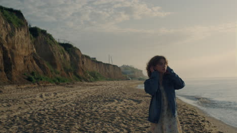 Dreamy-girl-walking-on-ocean-beach.-Stylish-woman-watching-sea-landscape