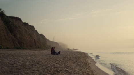 Romantic-couple-enjoying-sunset-at-ocean.-Loving-woman-and-man-dating-on-beach.