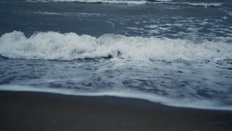 Waves-foam-splash-beach-in-sea-background-landscape.-Blue-ocean-water-surface.