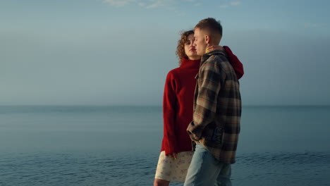 Sensual-woman-embracing-man-on-sea-beach.-Couple-enjoying-romantic-time-at-ocean