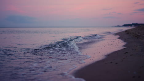 Purple-sky-reflecting-at-sea-water-surface-at-cold-evening-sunset.-Calm-waves