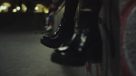 Woman-shoes-legs-moving-at-late-night-city-in-urban-background.