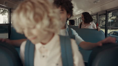 Diverse-school-teens-getting-out-schoolbus.-Children-leaving-academic-shuttle.