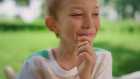 Portrait-of-funny-eating-boy-on-summer-picnic.-Child-laugh-on-camera-close-up.