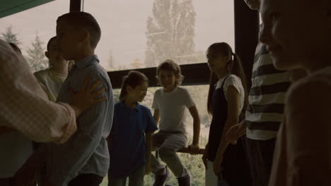 Angry-schoolchildren-pushing-aggression-victim-mocking-together-in-hallway.