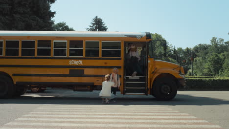 Mother-accompany-little-son-to-school-transport.-School-boy-boarding-yellow-bus.