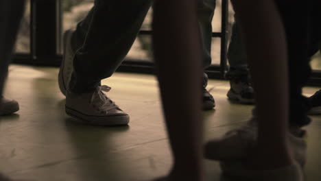 Closeup-children-legs-standing-group-on-hallway.-Bullies-group-pushing-outcast.