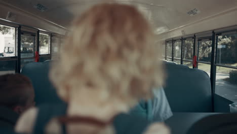 Teen-school-children-boarding-on-empty-shuttle.-Pupils-taking-seats-in-transport