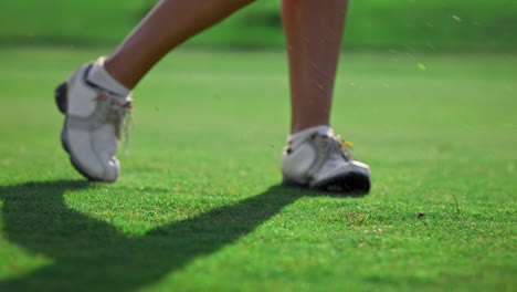 Lady-golfer-legs-training-wear-white-sneakers-at-country-club-course-grass-field