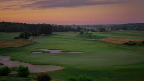 Aerial-golf-park-sunset-at-cloud-sky-nature-landscape.-Golfing-field-background.