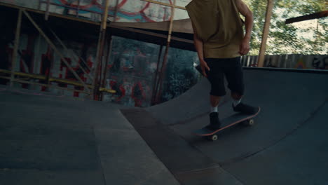 Skate-boarder-doing-tricks-in-bowl-at-urban-skatepark.-Rider-training-skills.