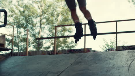 Hipster-performing-jump-trick-at-urban-skate-park.-Teen-rollerskating-in-ramp.