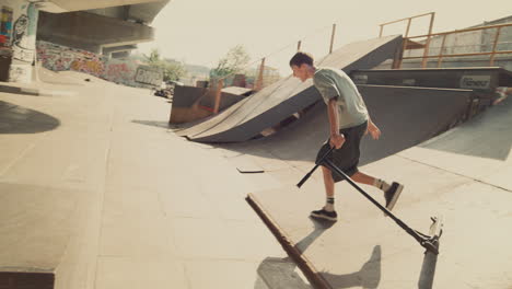 Extreme-rider-failing-stunt-on-scooter-at-urban-skate-park.-Sport-activity-time.