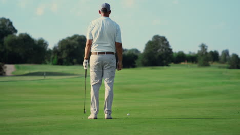 Man-standing-golf-course-alone-outdoors.-Sport-player-enjoy-fresh-air-in-summer.