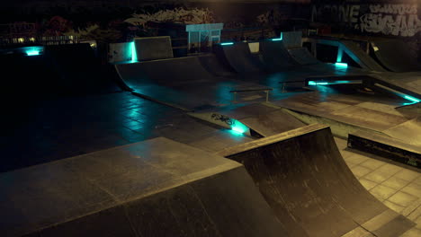Energetic-guy-jumping-roller-skates-in-safety-helmet-at-night-skate-park.