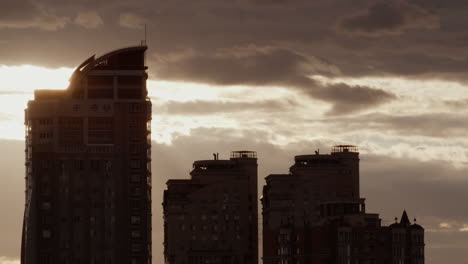 Urban-architecture-silhouette-drone-shot.-City-sunset-blocks-flats-at-cloudy-sky